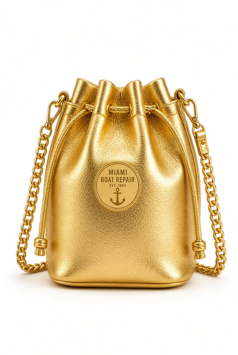 Miami Boat Repair Gold Bucket Bag with chain strap and embossed anchor medallion