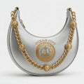 Ocean City Yacht Club silver metallic crescent hobo bag with embossed lighthouse crest Est. 1994 and gold chain strap with lion head medallion charms
