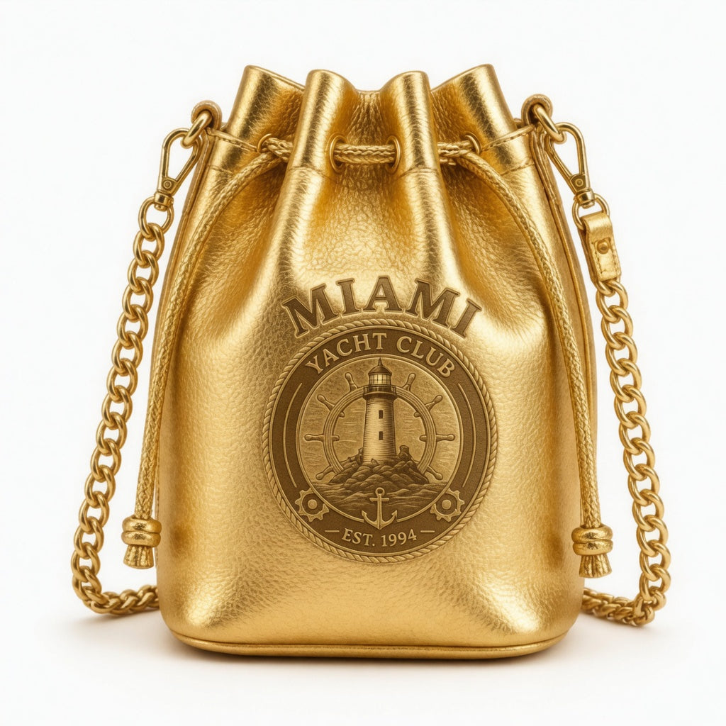 Gold metallic bucket bag with Miami Yacht Club nautical medallion, chain strap, Est. 1994